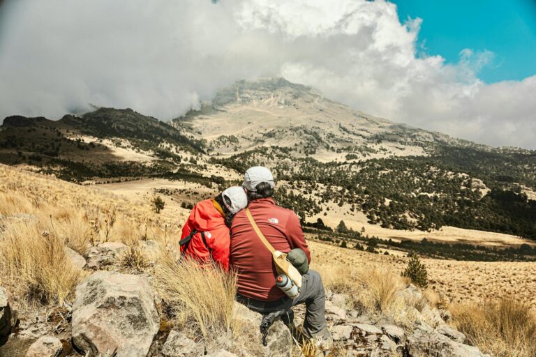 Family enjoying a scenic hike with a stunning mountain view in the background.