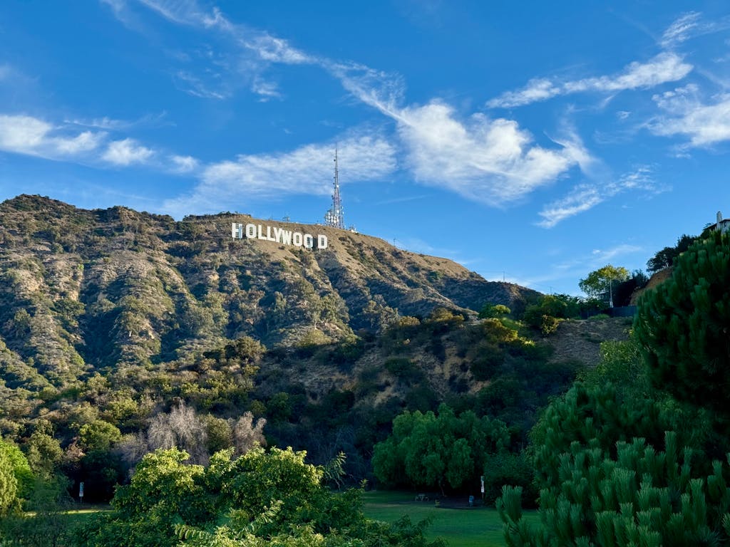 View of the famous Hollywood Sign in Los Angeles, California, showcasing scenic hills and clear skies.